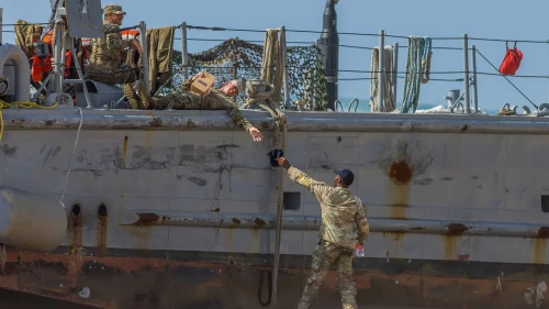 U.S. military personnel at a U.S. Army vessel that washed up on the beach in Ashdod, May 25, 2024. Photo by Liron Moldovan/Flash90.