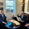 Prime Minister Benjamin Netanyahu holds an autographed copy of Chinese President Xi Jinping's book that Ambassador Cai Run gave him during their meeting in Jerusalem, July 26, 2023. Credit: Prime Minister's Office.