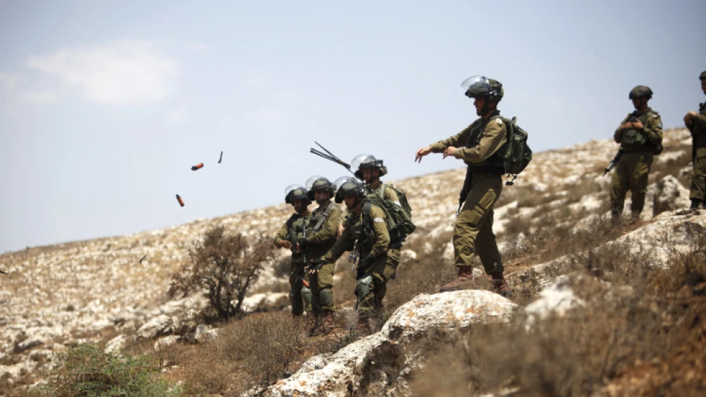 Israeli soldiers clash with Palestinians during a protest in the village of Beit Dajan near Nablus on July 16, 2021. Photo by Nasser Ishtayeh/Flash90.