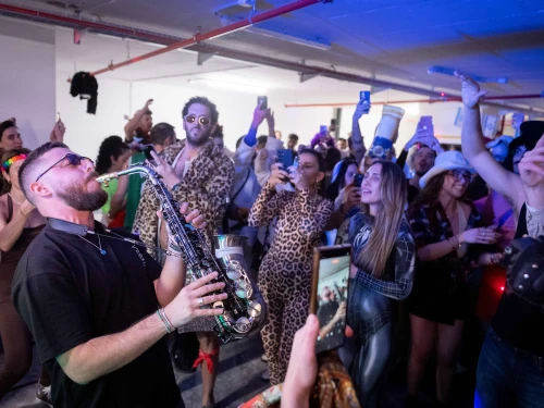 People dance during the Jewish holiday of Purim at an underground parking lot amid missile attacks emanating from the Islamic Republic, March 2, 2026. Photo by Chaim Goldberg/Flash90.