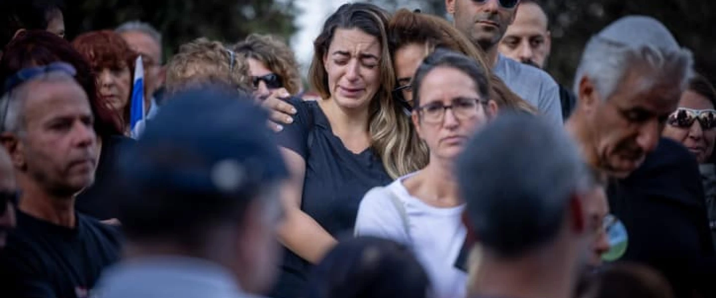 Mourners attend the funeral at Kibbutz Beit Guvrin on Tuesday of Yosef Vahab, whom Hamas terrorists murdered in Kibbutz Nir Oz on Oct. 7. Photo by Yonatan Sindel/Flash90.