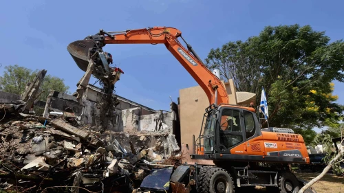 A bulldozer demolishes a house that was damaged during the Oct. 7 massacre in Kibbutz Be'eri, as part of a project to rebuild the destroyed homes and infrastructure in the kibbutz, July 7, 2024. Photo by Oren Cohen/Flash90.