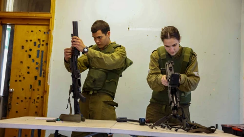 Israel Defense Forces troops clean their weapons ahead of a training session near the country's northern border with Lebanon, Jan. 16, 2024. Photo by David Cohen/Flash90.