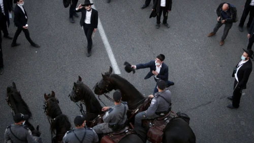 Ultra-Orthodox Jews in Bnei Brak clash with police as they protest against the arrest of haredi men who failed to comply with their army draft notice, Dec. 27, 2020. Photo by Noam Revkin Fenton/Flash90.
