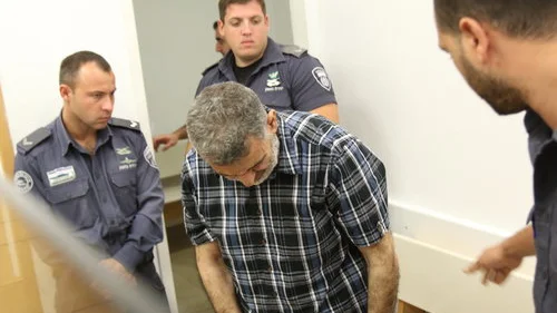 In August 2015, Swedish-Lebanese national Hassan Khalil Hizran (center)—at the time accused, and later convicted of being recruited by the Hezbollah terrorist group to enlist Israeli-Arab operatives with access to soldiers, members of the security services and government officials—is pictured at the District Court in Lod, Israel. Credit: Flash90.