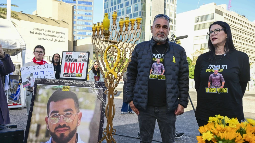 Relatives, friends and supporters of Master Sgt. Ran Gvili, whose body is held by Hamas, attend a Kabbalat Shabbat ceremony and the lighting of Chanukah candles at Hostages Square in Tel Aviv, calling for the return of his body from Hamas captivity, on Dec. 19, 2025. Photo by Avshalom Sassoni/Flash90.
