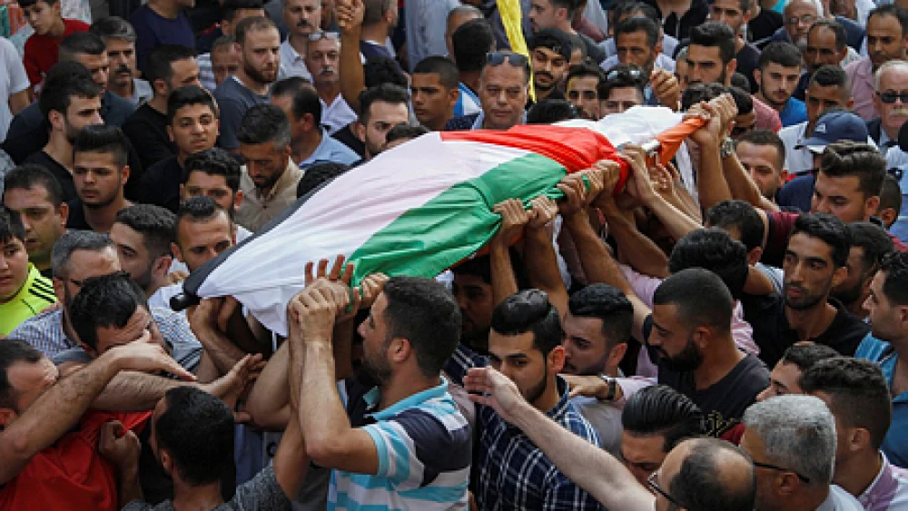 Palestinians carry the body of 48-year-old mother of eight Aisha Rabi, who died of her wounds after the car she was traveling in with her husband was hit by stones, during her funeral in the West Bank village of Bidya on Oct. 13, 2018. Credit: Nasser Ishtayeh/Flash90.