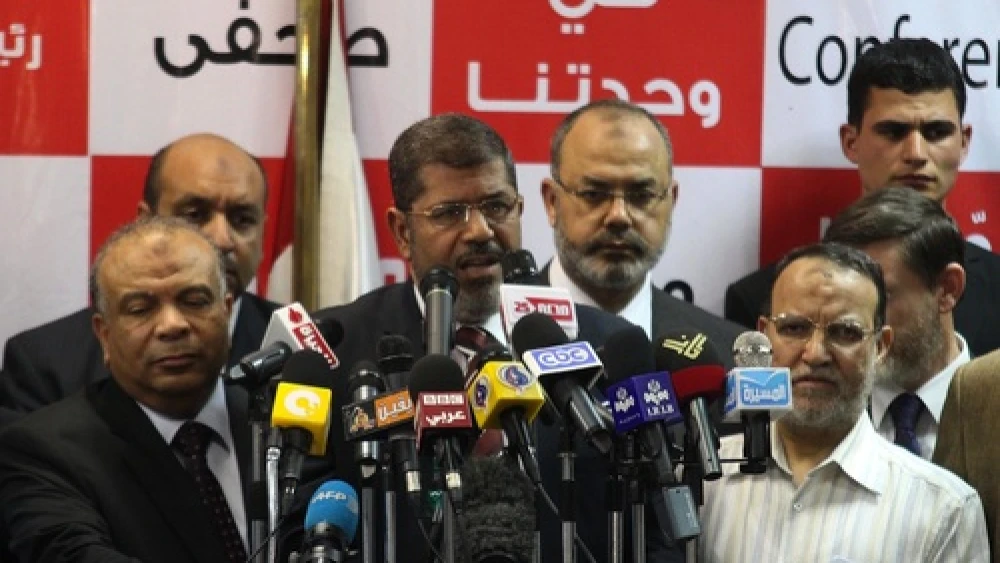 Egypt's Muslim Brotherhood presidential candidate Mohammed Morsi (center) speaks during a press conference in Cairo on June 18, 2012. The Muslim Brotherhood claimed victory in Egypt's first presidential election since Hosni Mubarak was ousted more than a year ago. Credit: EPA/AHMED KHALED.