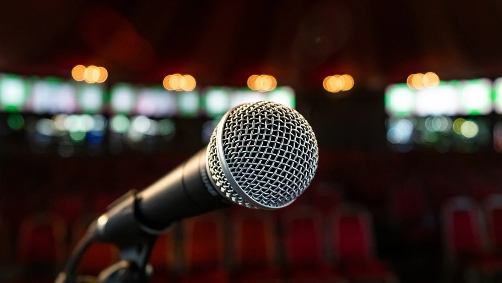 A microphone on a stand at a comedy venue at the Edinburgh Fringe Arts Festival. Source: Shutterstock.