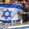 Israelis place memorial candles on the sidewalk at the site of the April 7, 2022 terrorist attack in Tel Aviv. Photo by Noam Revkin Fenton/Flash90.