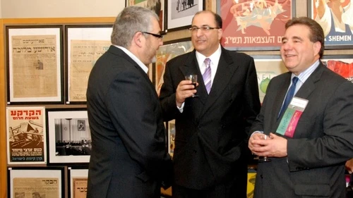 Aharon Farkash (left), director of the Farkash Gallery in Israel, joins Israel's Consul General in New York Ido Aharoni and Jewish National Fund CEO Russel F. Robinson March 28 at the opening of the "Made in Israel 2012" exhibit (which can be seen in the background). Credit: Maxine Dovere.