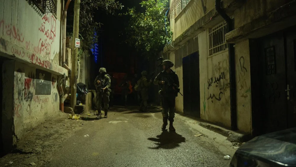 Israeli soldiers from the Duvdevan Unit operate in an alley during an overnight raid in the Binyamin area of Judea and Samaria, in this handout photo released July 15, 2026. Credit: IDF.