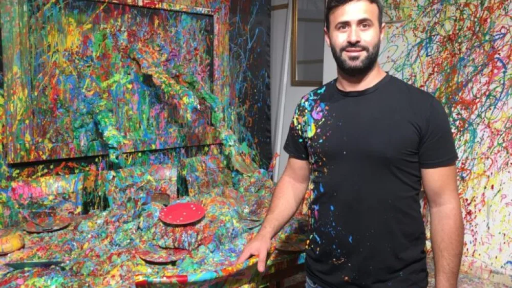 Sam Halabi by the dining room table in his childhood home.