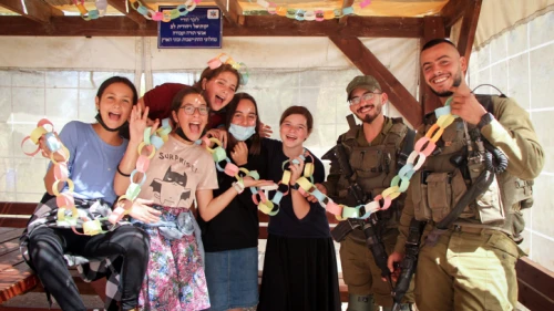 Students from the Orot Etzion school decorate a sukkah at the Oz veGaon Nature Preserve near the Gush Etzion junction, Sept. 19, 2021. Photo by Gershon Elinson/Flash90.