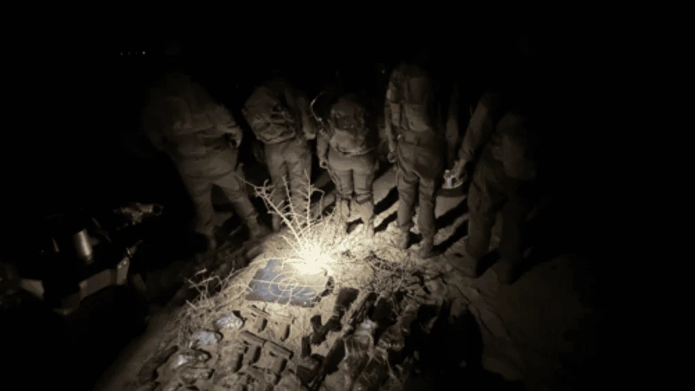 IDF troops display some of the arms smuggled by drones across the Egyptian border to Israel earlier this year. Credit: IDF.