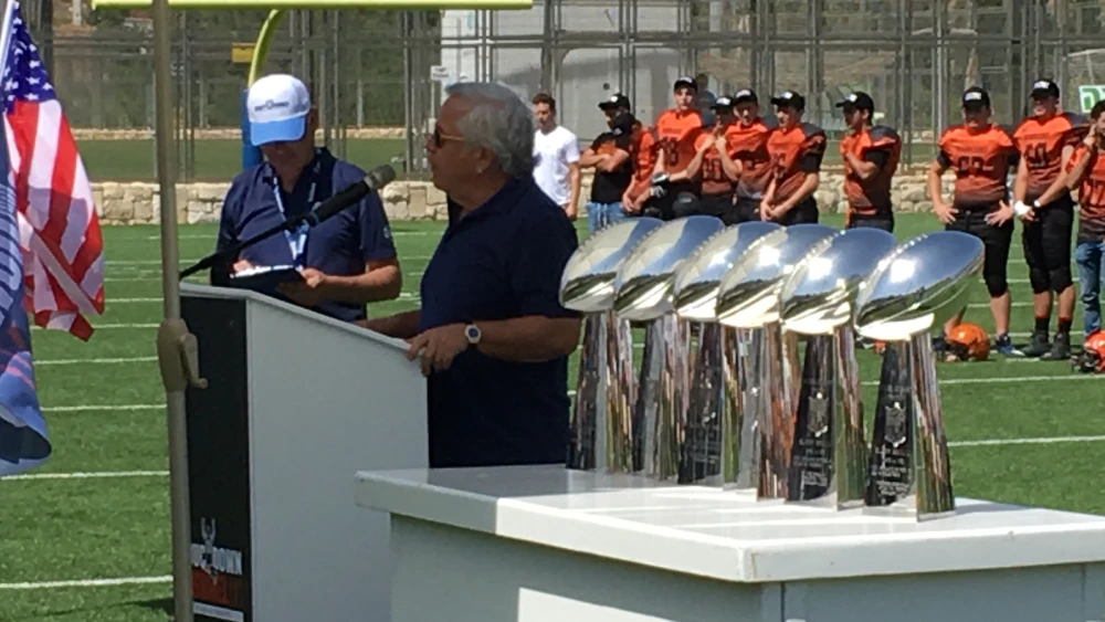Patriots chairman and CEO Robert Kraft speaking next to his team’s Lombardi trophies. Photo by Josh Hasten.