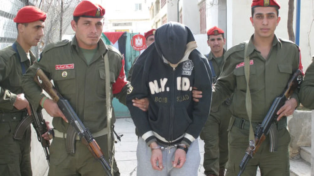Mohanad Abo Jodah, an officer in Palestinian Authority leader Mahmoud Abbas's National Security Forces, is held by P.A. police after he was sentenced to death by a Palestinian military court in Hebron on Jan. 25, 2009. Credit: Najeh Hashlamoun/Flash90.