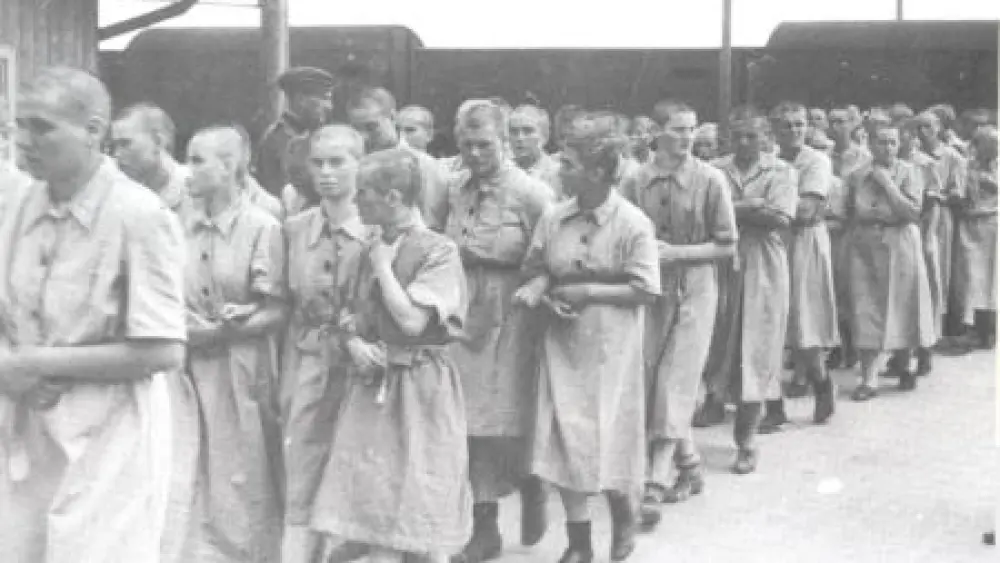 A photograph taken by a Nazi guard of the women entering the camp after having their heads shaved. Lydia Lebovic is in the middle of the photograph. Credit: Courtesy.