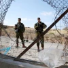Israeli soldiers at a breach in the security fence, near Hebron, May 23, 2021. Photo by Wisam Hashlamoun.