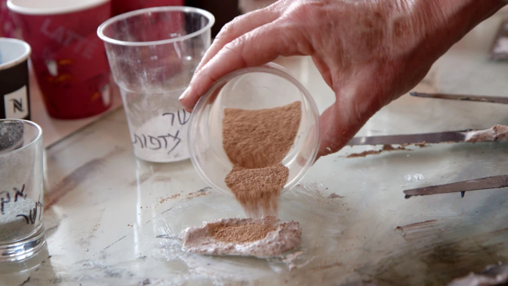 Pouring the fine granules. Credit: Photo by Tor Ben Mayor.