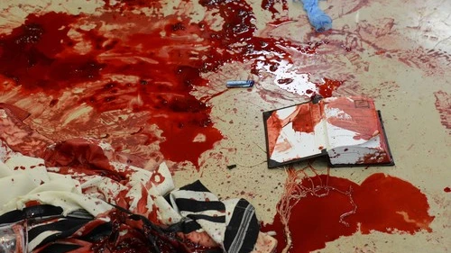 Blood on prayer shawls and a siddur inside the Kehilat Bnei Torah synagogue in Jerusalem following the terrorist attack that took place there on Nov. 18, 2014. Cerdit: Kobi Gideon/GPO/Flash90.