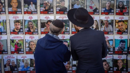 Jews gaze at photos of Israelis held captive by Hamas terrorists in Gaza, at the Western Wall Plaza in Jerusalem, Jan. 10, 2024. Photo by Chaim Goldberg/Flash90.