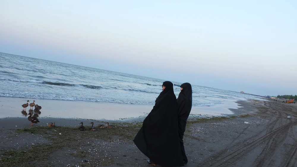 Two chador clad women stand on an empty beach by the Caspian Sea on September 5, 2012 in Bandar Anzali, Iran. Photo by Kaveh Kazemi/Getty Images.