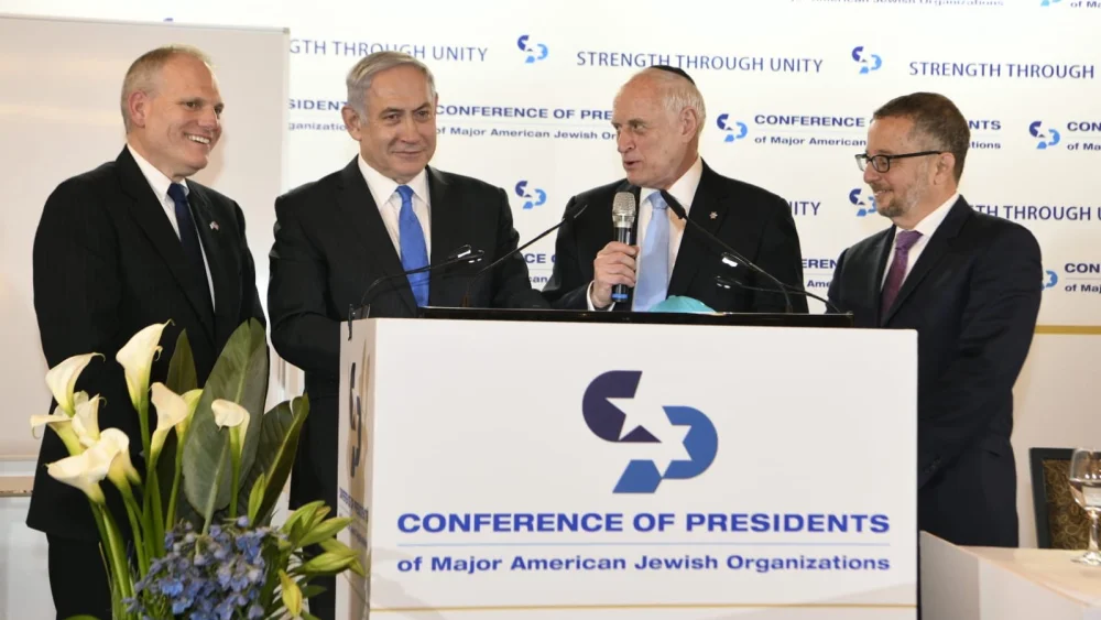 From left: Conference of Presidents CEO William Daroff, Israeli Prime Minister Benjamin Netanyahu, then-executive vice chairman Malcolm Hoenlein and then-chairman Arthur Stark speaking at the 2020 Conference of Presidents Summit in Jerusalem. Source: Conference of Presidents/X.