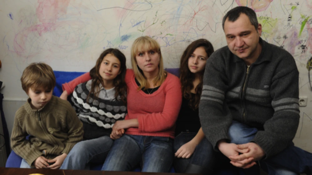 Click photo to download. Caption: With no money to replace the decayed wallpaper in their poorly insulated three-room apartment in Bulgaria, parents Harry and Yana allowed their three children to simply draw on the walls to bring cheer to their home. Economic hardships afflicting Europe pose a dire a threat to Jews, writes Alan H. Gill, CEO of the American Jewish Joint Distribution Committee (JDC). Credit: JDC.