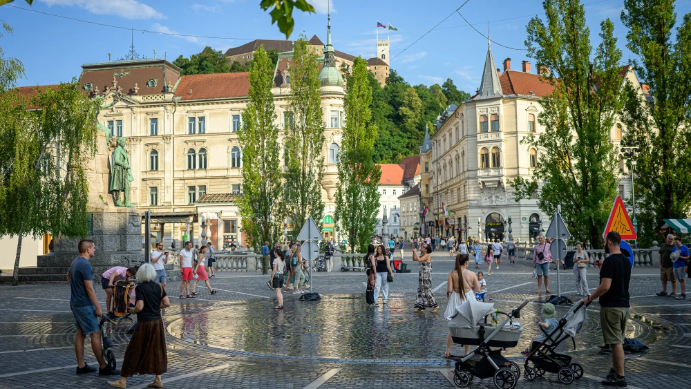 Pedestrians cool off at "The area with Ljubljana's own weather" in Preseren Square in Ljubljana on June 24, 2026. Photo by Jure Makovec / AFP via Getty Images.