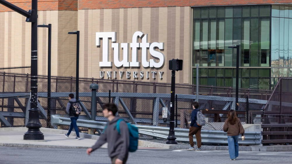 People walk on College Avenue near Tufts University in Medford, Mass., on March 27, 2025. Photo by Scott Eisen/Getty Images.