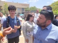 Almog Cohen, right, speaks with protesters demonstrating against Yair Golan at a conference in Be'er Sheva, Israel on may 27, 025. Photo by Canaan Lidor.