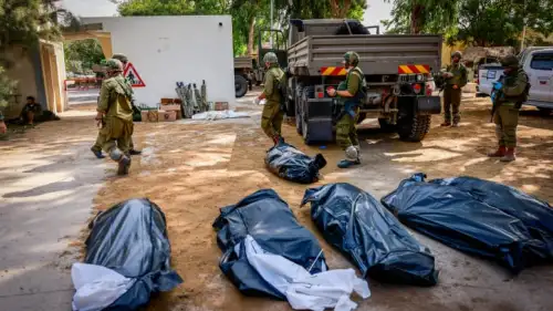 IDF soldiers remove the corpses of civilians in Kibbutz Kfar Aza, near the Gaza Strip, Oct. 10, 2023. Photo by Chaim Goldberg/Flash90.