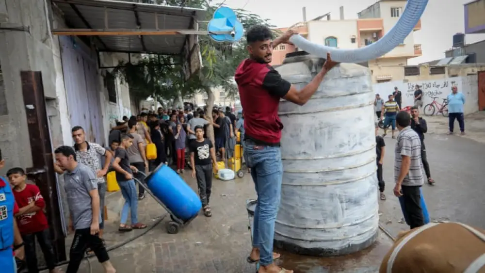 Palestinians wait to collect water using horse- and donkey-drawn carts, in Rafah in the southern Gaza Strip, Oct. 28, 2023. Photo by Abed Rahim Khatib/Flash90.