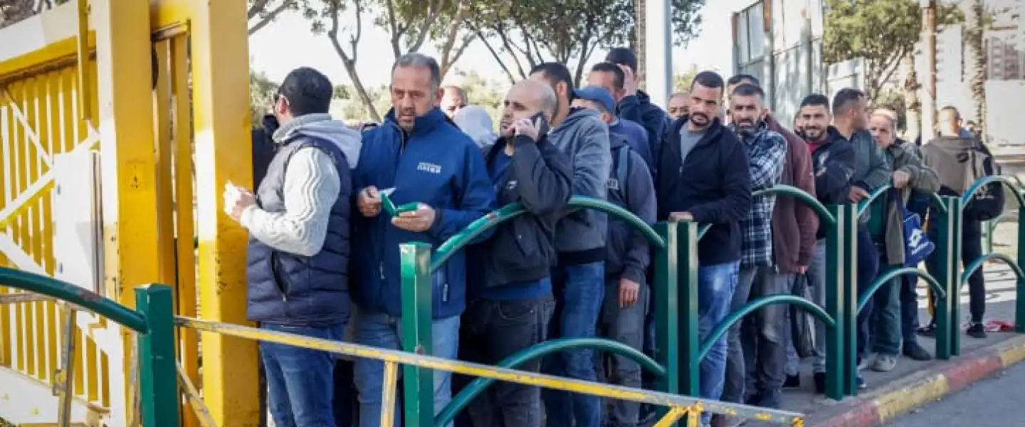 Palestinian workers line up at the entrance to Ma'ale Adumim near Jerusalem, Feb. 23, 2023. Photo by Erik Marmor/Flash90.