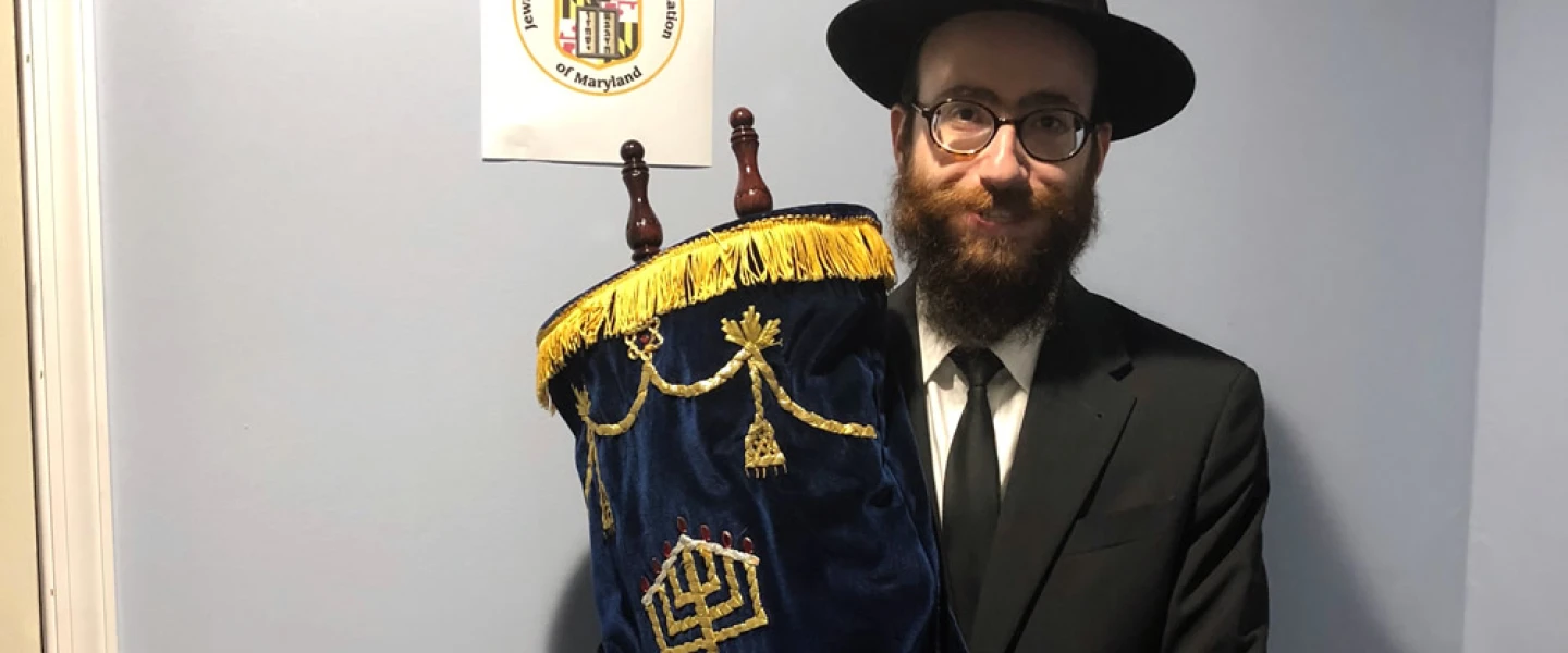 Chabad Rabbi Yechezkiel (“Chesky”) Tenenbaum, chaplain of the Maryland Defense Force, which is part of the Maryland Military Department. He holds a newly refurbished Torah on loan that was named after a Jewish American soldier who served in Afghanistan. Credit: Courtesy.