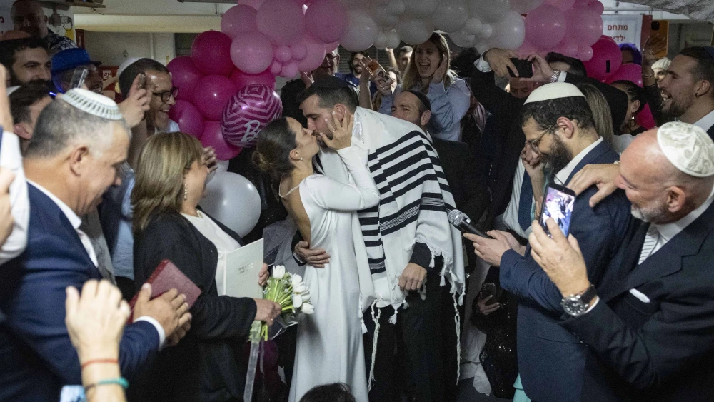A couple enjoys their wedding ceremony held in an underground parking lot in Tel Aviv used as a protected space amid the war with Iran, March 3, 2026. Photo by Chaim Goldberg/Flash90.