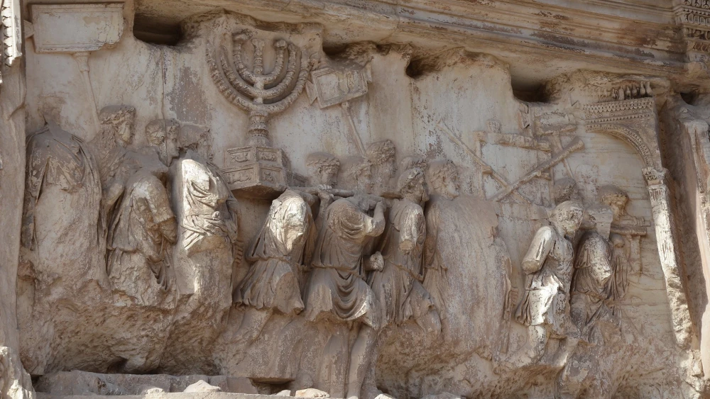 The Arch of Titus in Rome. The arch contains panels depicting the triumphal procession celebrated in 71 C.E. after the Roman victory culminating in the fall of Jerusalem, which is mourned on the Jewish holiday of Tisha B'Av. Credit: Flickr.
