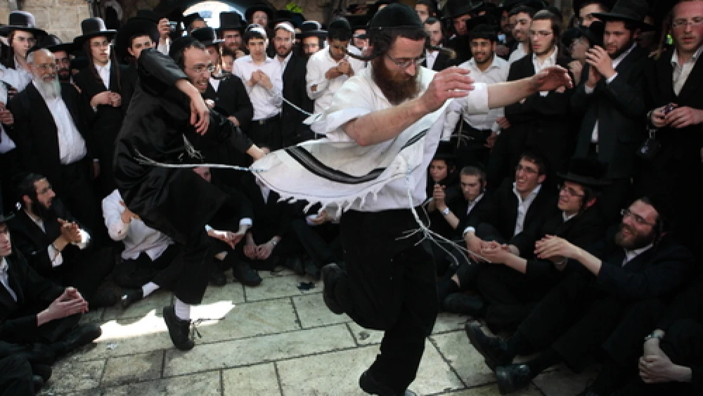 Orthodox Jewish men dance as they take part in celebrations of the Jewish holiday of Lag B'Omer at Mount Meron in northern Israel on May 22, 2013. Credit: Yaakov Naumi/Flash90.