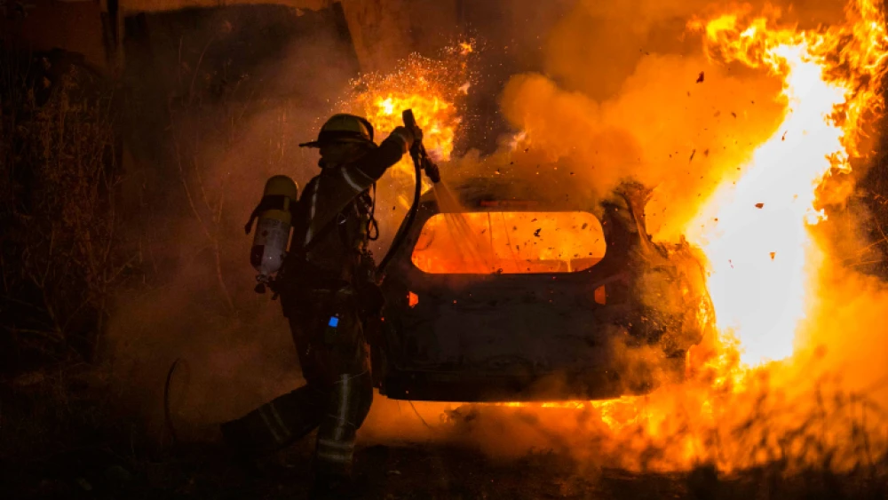 Firefighters extinguish a fire set during a protest against an expected eviction by Israel's Supreme Court of several Palestinian families living in Jewish-owned homes in the eastern Jerusalem neighborhood of Sheikh Jarrah on May 6, 2021. Photo by Olivier Fitoussi/Flash90.