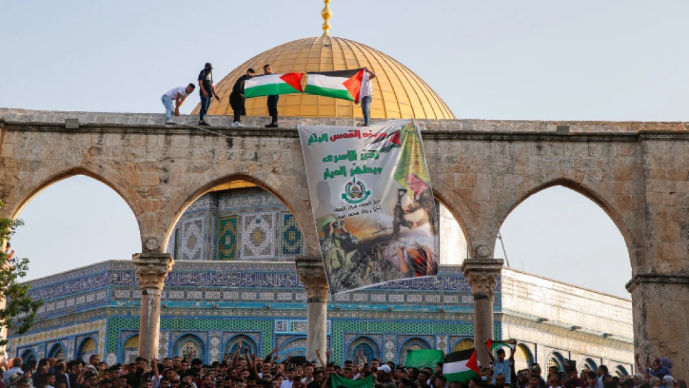 Palestinians protest as thousands attend prayers at the Al-Aqsa mosque on the Temple Mount marking the Muslim holiday of Eid al-Adha, July 20, 2021. Photo by Jamal Awad/Flash90.