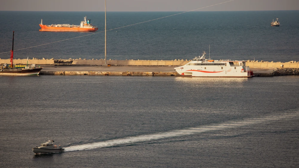 A police speed boat patrols the port as oil tankers and high speed crafts sit anchored at Muscat Anchorage near the Strait of Hormuz.