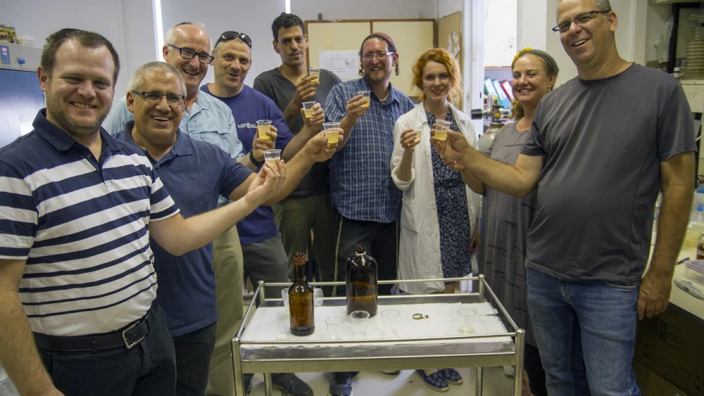 The team of researchers with new/old beer bottles produced in the labs. Credit: Yaniv Berman, courtesy of the Israel Antiquities Authority.