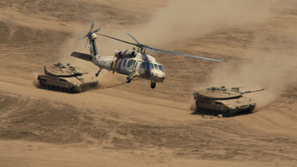 A Black Hawk helicopter and Merkava Tanks during an Israel Defense Forces drill in the the Golan Heights on Aug. 14, 2008. Photo by Moshe Shai/Flash90.