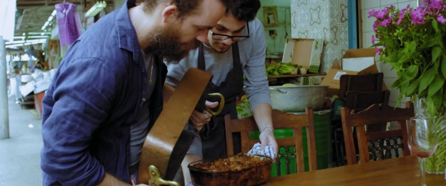 Chefs Ilan Ferron and Osama Dalal prepare to flip octopus maqluba in a scene from “Breaking Bread.” Photo courtesy of Cohen Media Group.