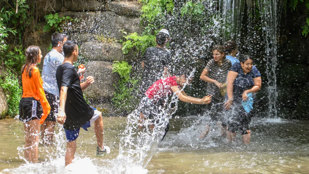 Israelis play in the springs and waterfalls of Snir Park in the Snir Valley, near the Jordan River, May 22, 2023. Photo: Ayal Margolin/FLASH90