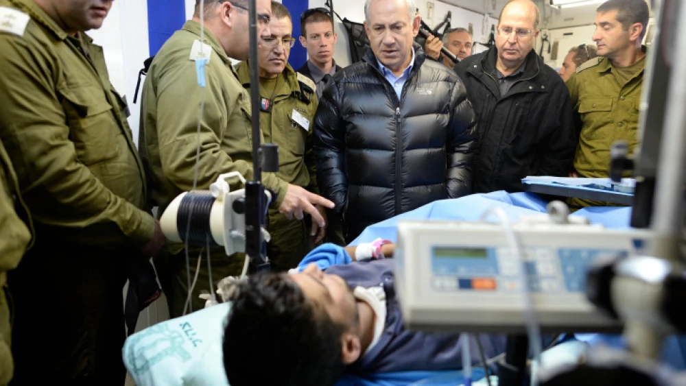 Israeli Prime Minister Benjamin Netanyahu visits at an IDF field hospital, where those wounded in the civil war in Syria were being treated in northern Israel. Feb. 18, 2014. Photo by Kobi Gideon/GPO/Flash90.
