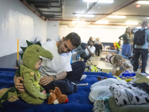 Israelis take cover from incoming missiles at an undergoing parking lot in Tel Aviv, March 3, 2026. Photo by Chaim Goldberg/Flash90.