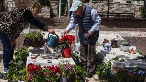 Yaakov Lubinewski, 99, tends the graves of two Israeli soldiers from his town killed during Hamas's Oct. 7 massacre, March 26, 2024. Credit: Rina Castelnuovo.