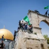 Protesters wave Hamas flags after Friday prayers, at the Al Aqsa mosque compound in Jerusalem's Old City, April 22, 2022. Photo by Jamal Awad/Flash90.